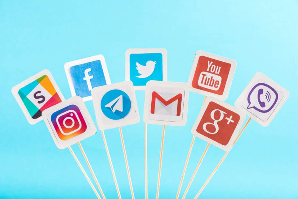 Social media icons on sticks on a WordPress blue background.